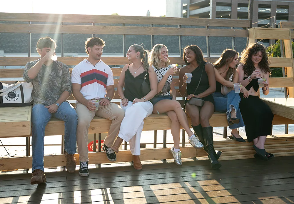 group of diverse young adults sitting outside